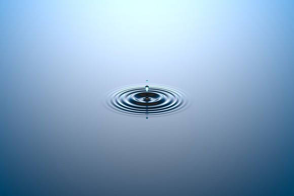 Water dropping onto a water surface.