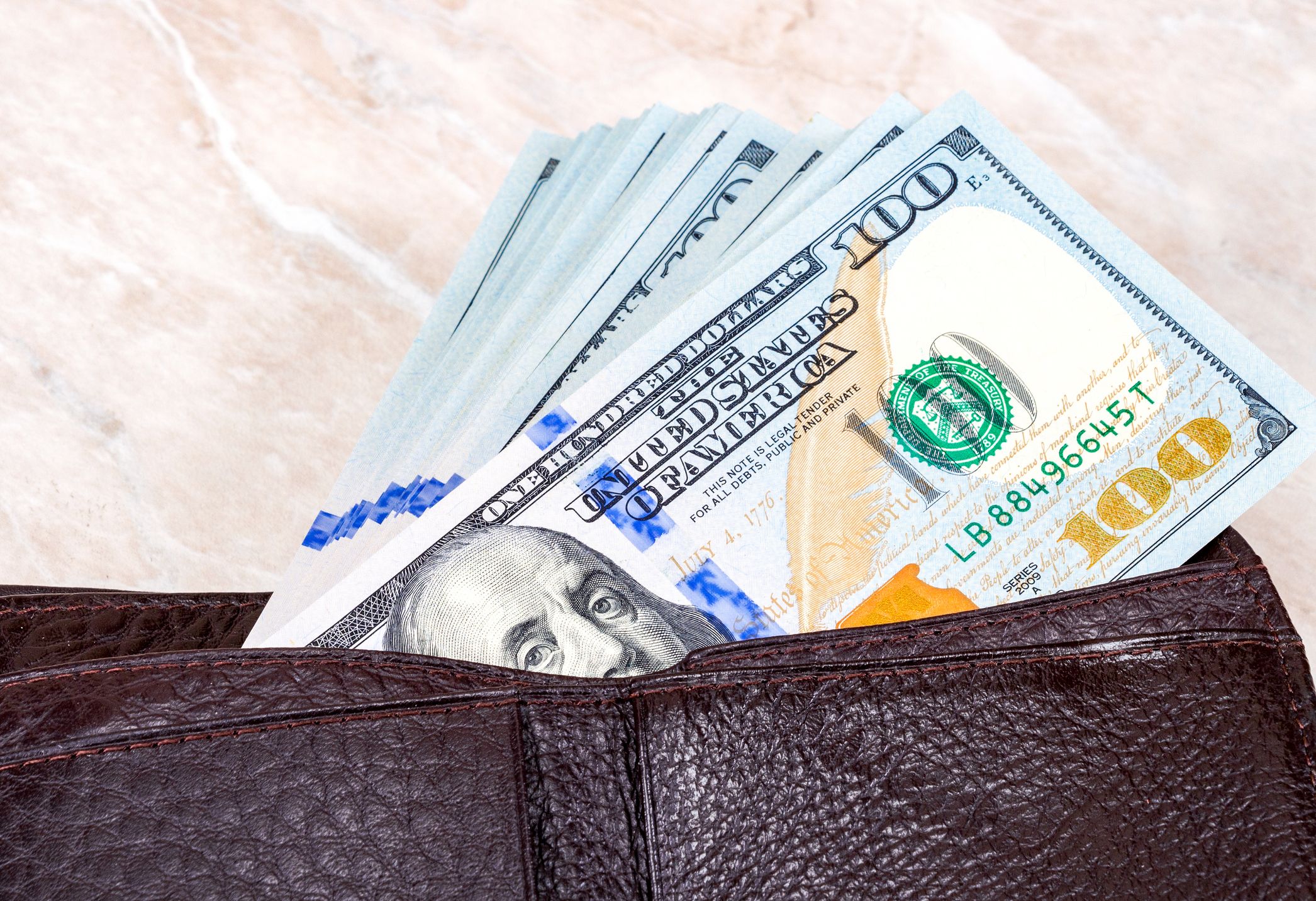 Wallet full of hundred dollar bills