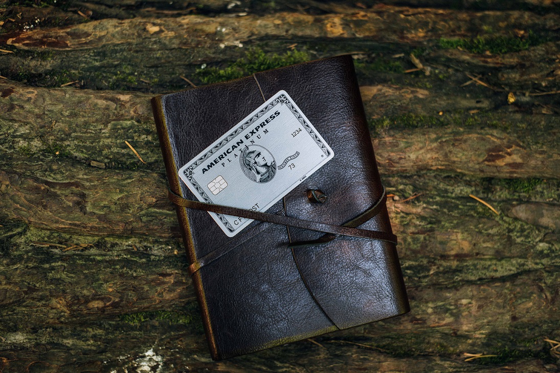 American Express Platinum card resting on a travel wallet.