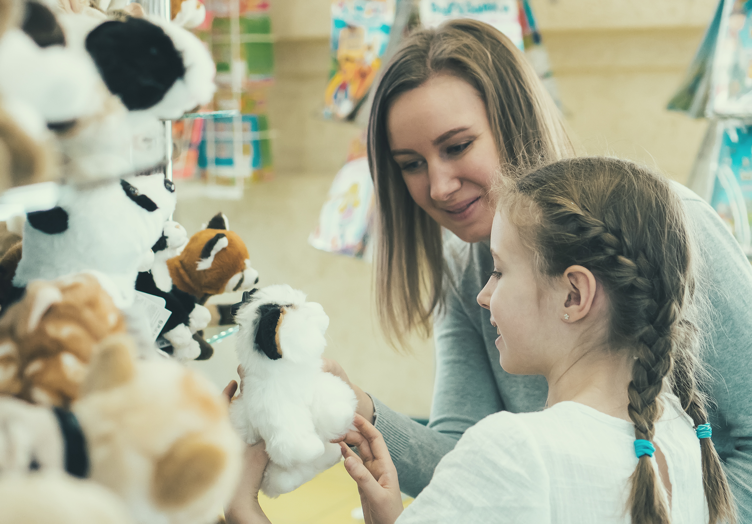 Mother and daughter looking at toys in a store