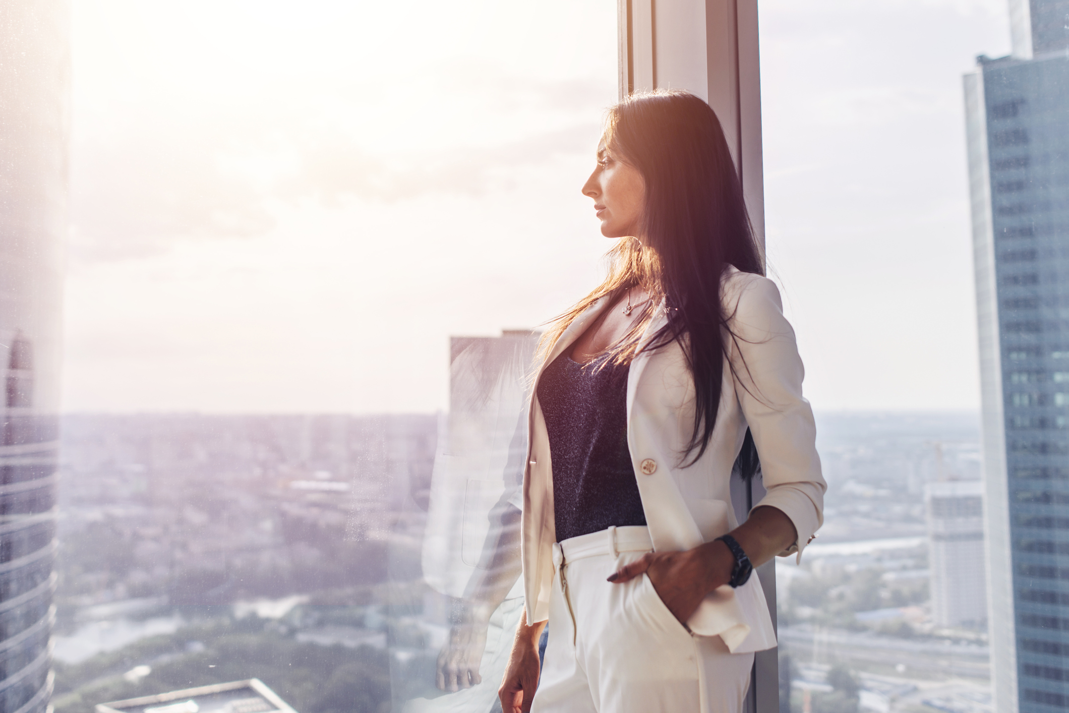 Woman in business suit looking out the window.