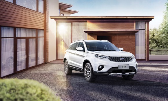 A white Ford Territory, a midsize SUV developed as an affordable entry for China, parked in front of a home.