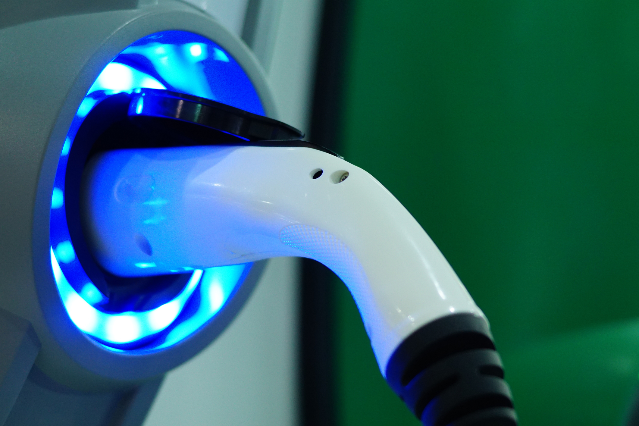 Electric vehicle charging station handset glowing blue