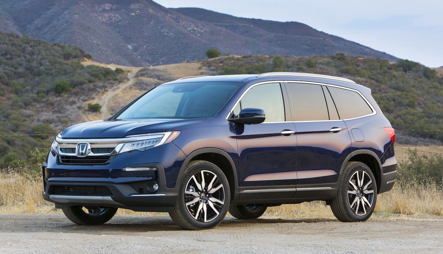 A dark blue 2019 Honda Pilot, a midsize crossover SUV.