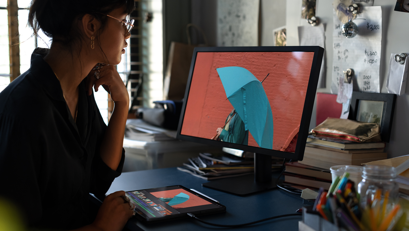 Woman using iPad Pro connected to a monitor