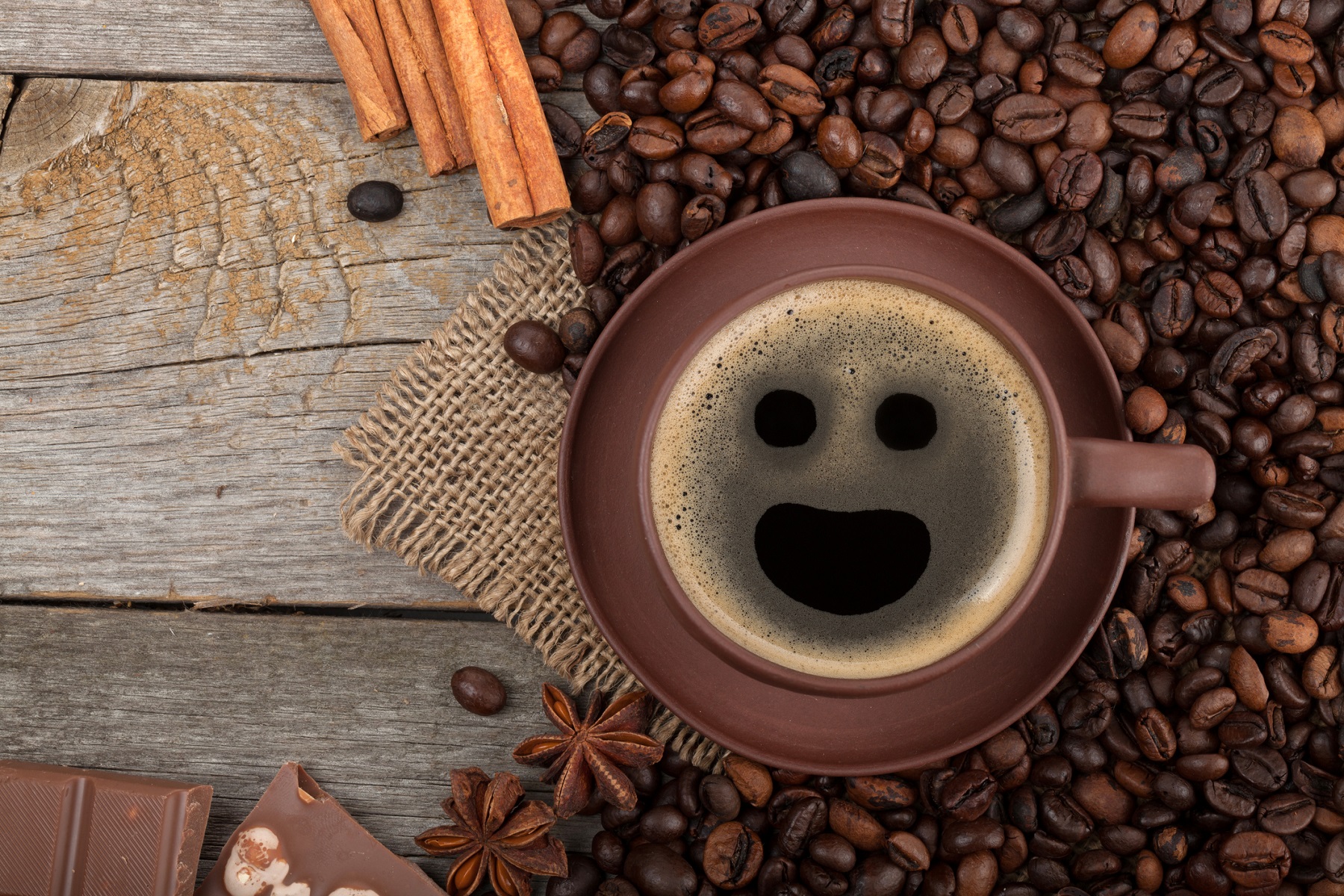 Cup of coffee with a smile in the foam.