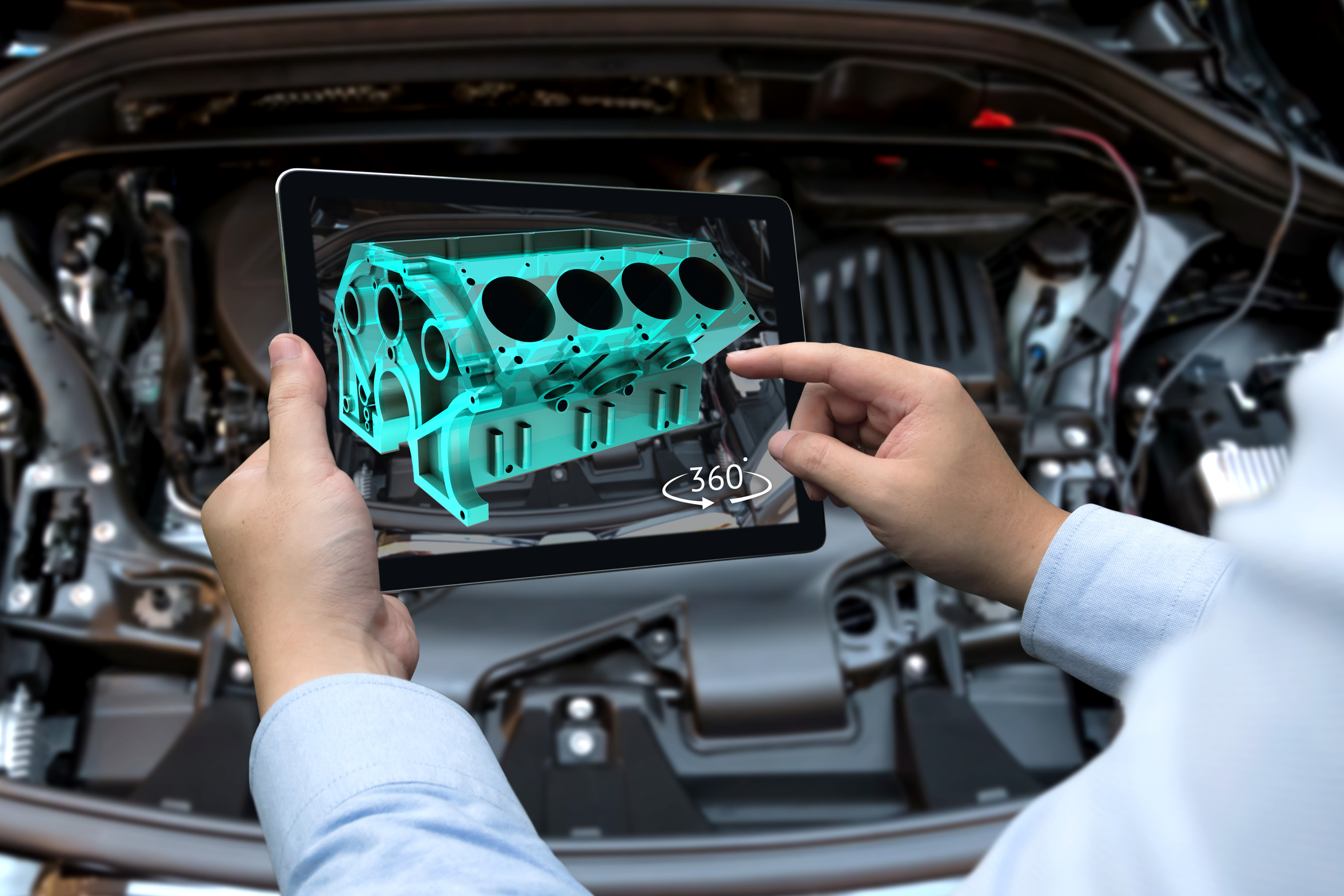 Man designing a vehicle engine block on tablet device.