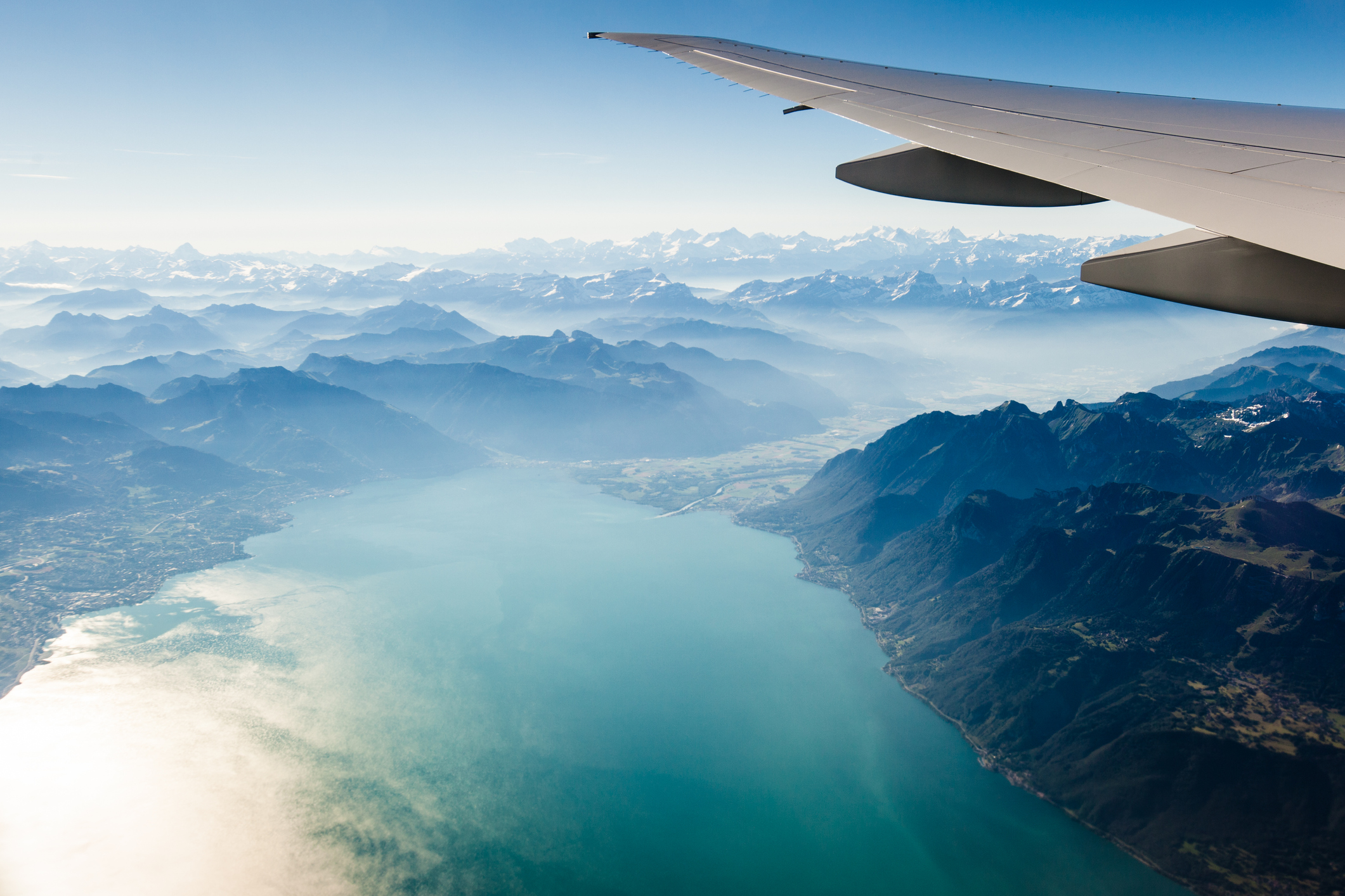 An airplane wing over some mountains