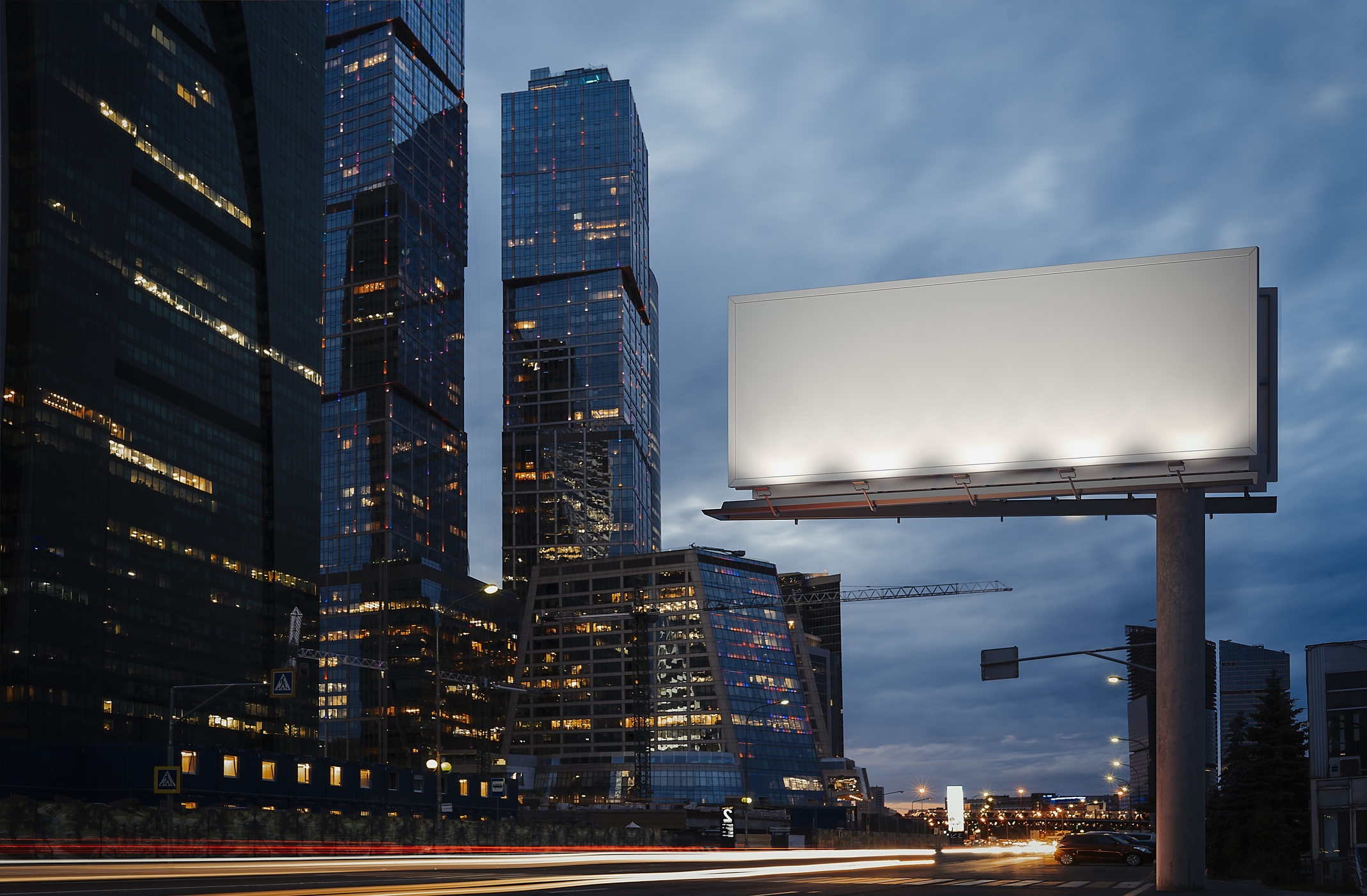 Time lapse of blank billboard next to highway and skyscrapers.