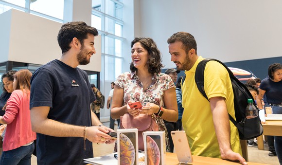 Customers shop in an Apple store.