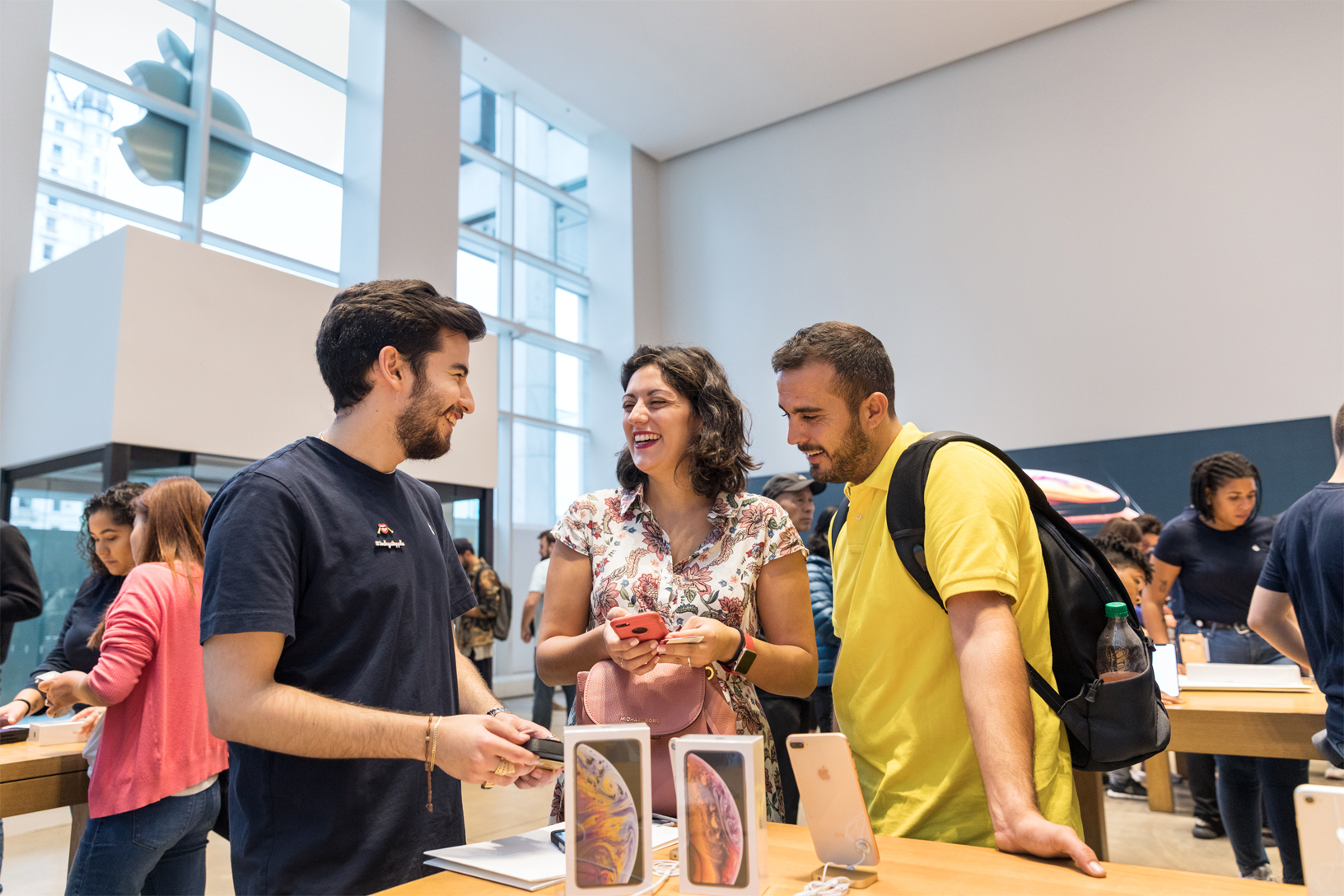 Customers shopping in an Apple store.