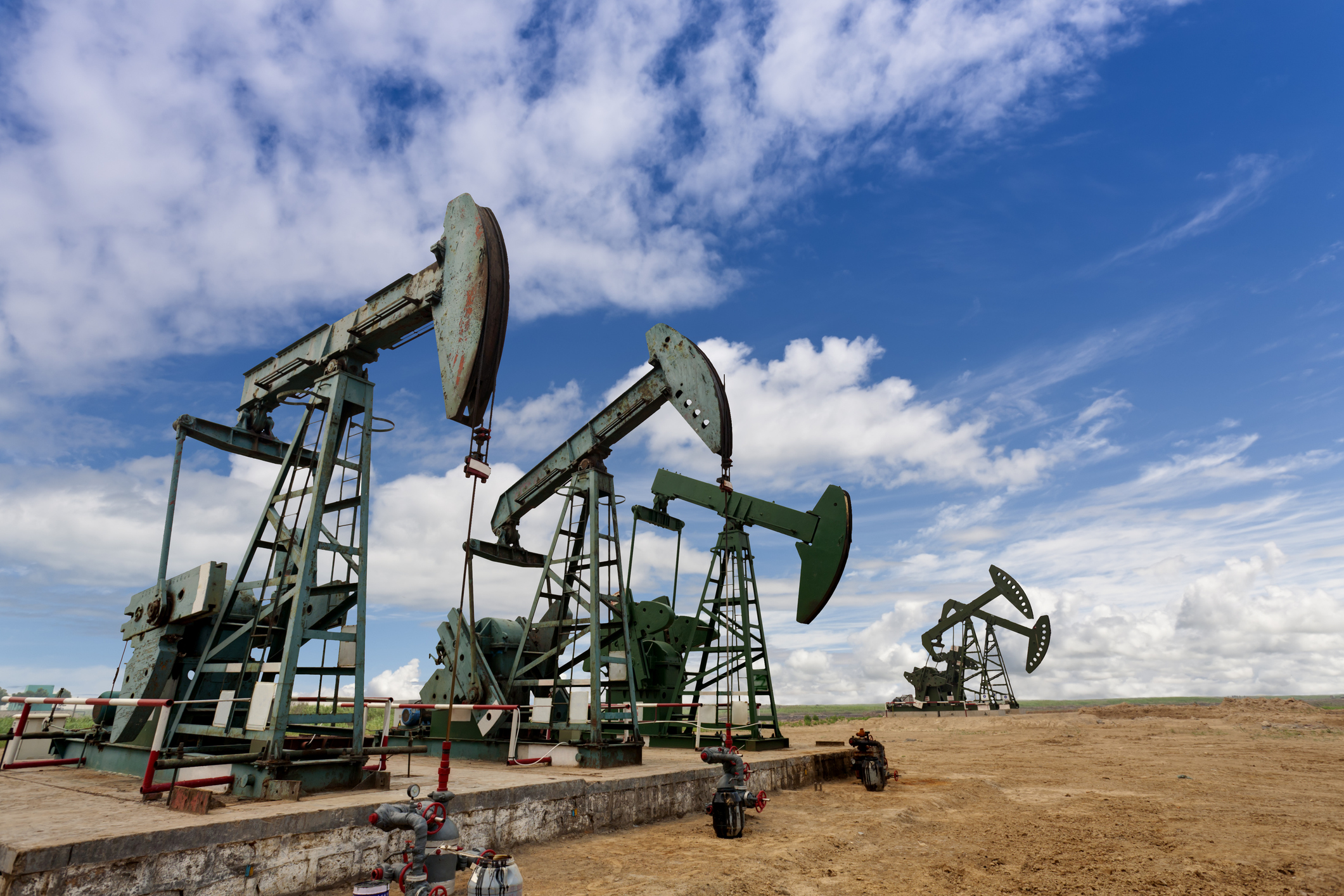 Several oil pumps in a field.