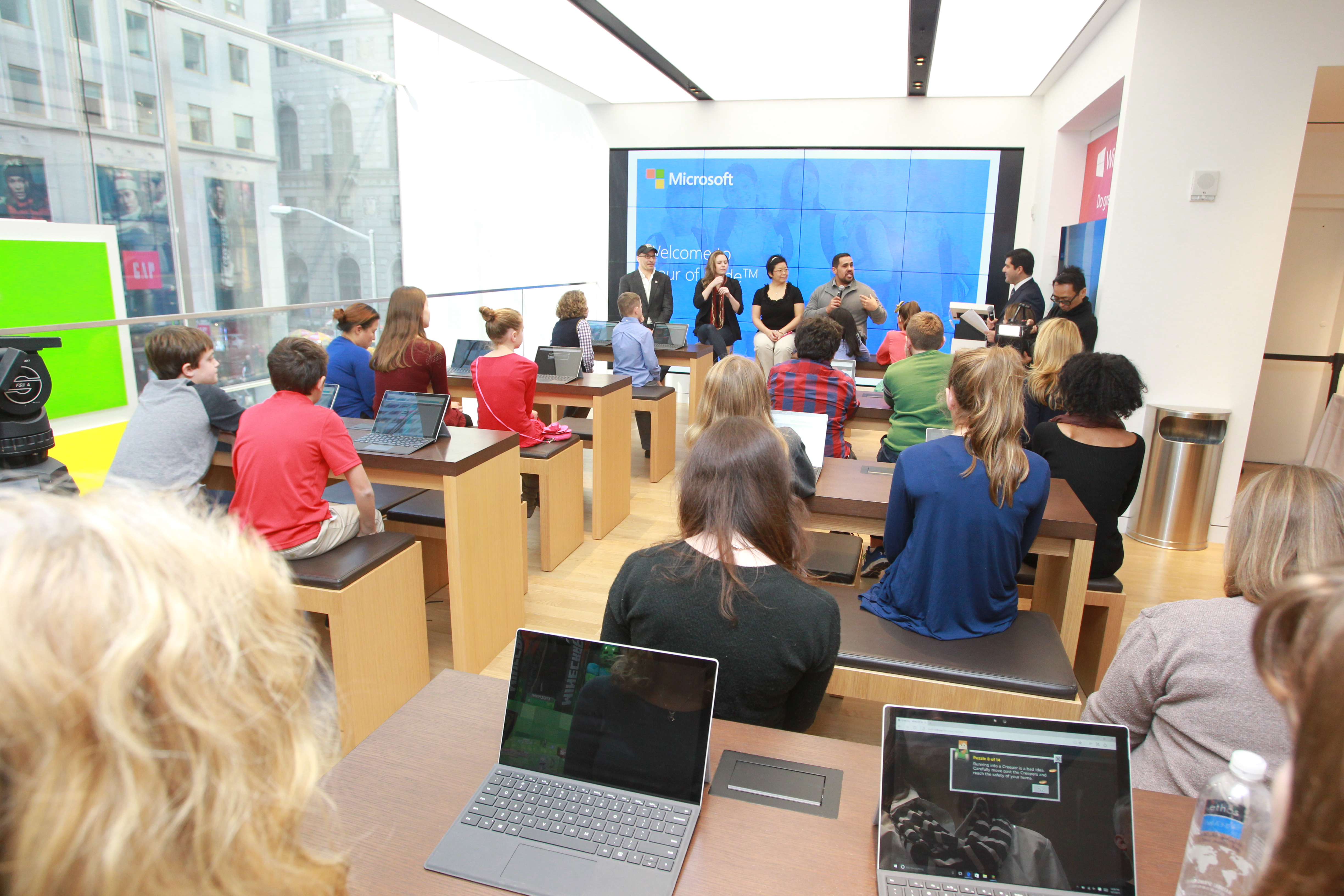 People inside of a Microsoft store during the company's "hour of code" session.