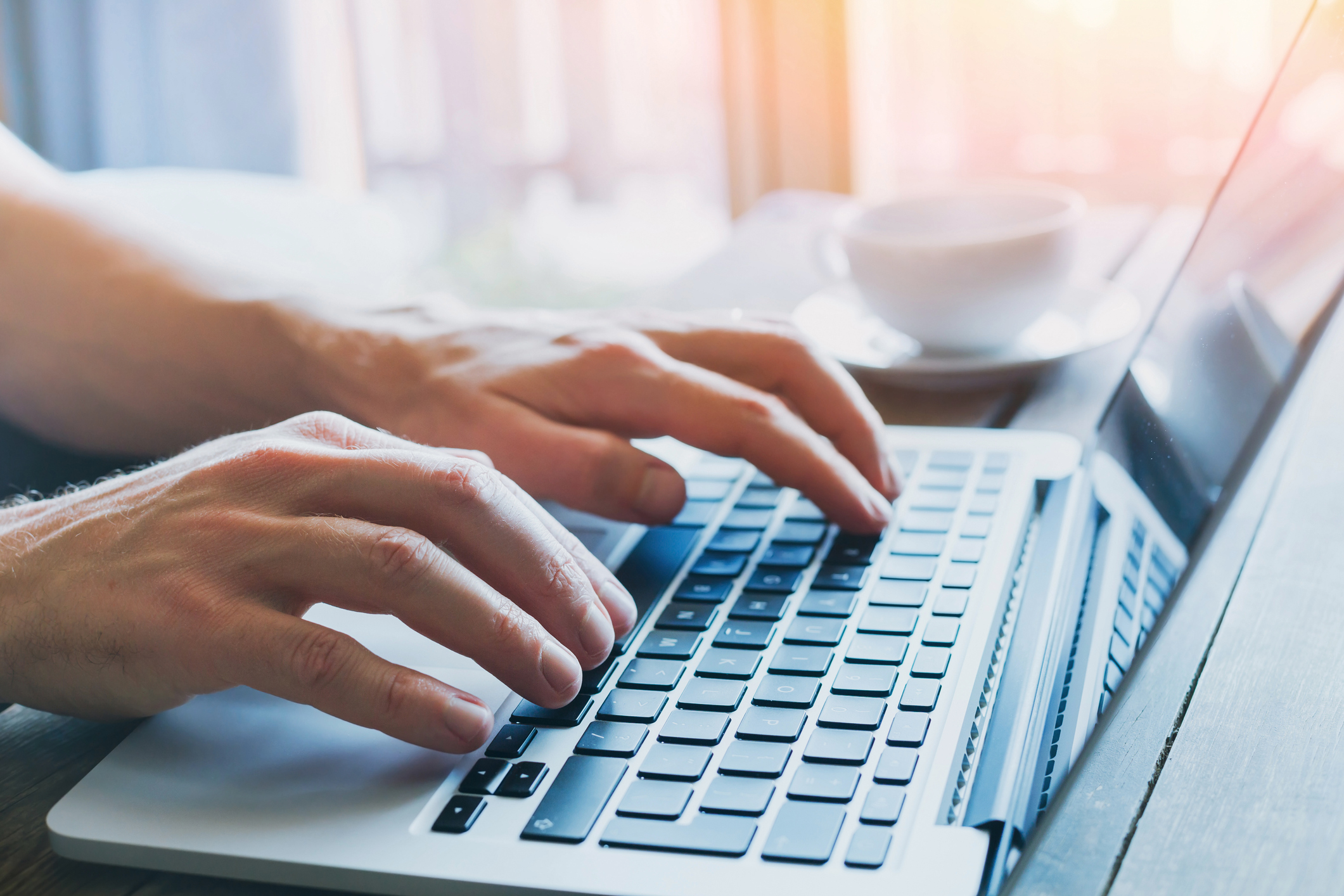 Person using a laptop keyboard.