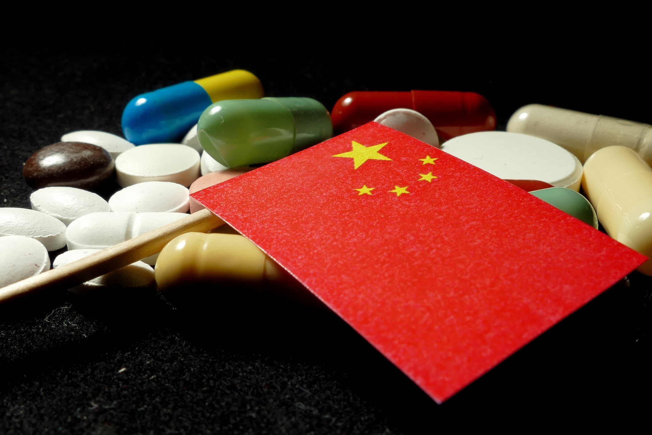 China flag on top of random pills and capsules.