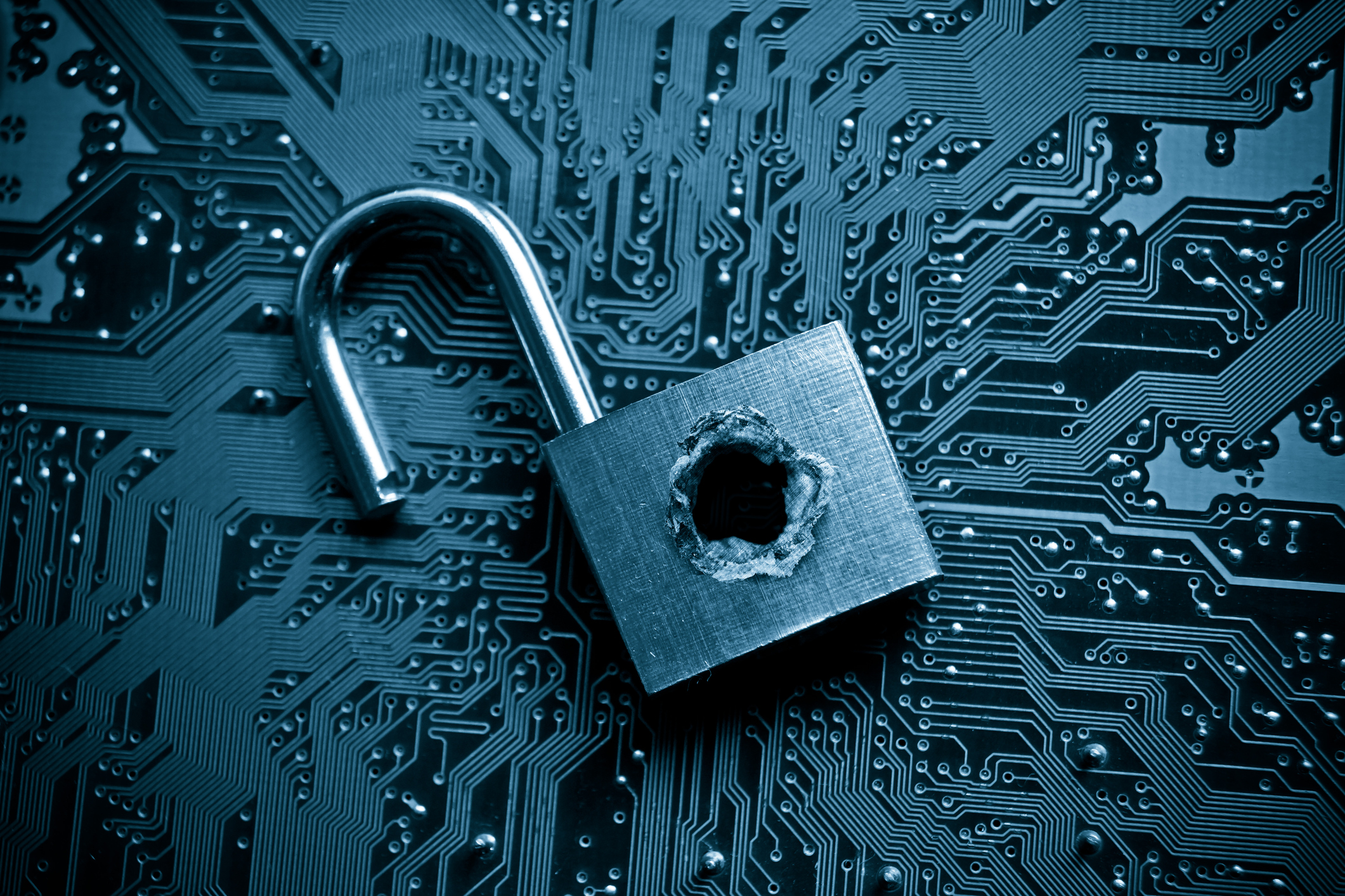 A broken padlock on top of a circuit board