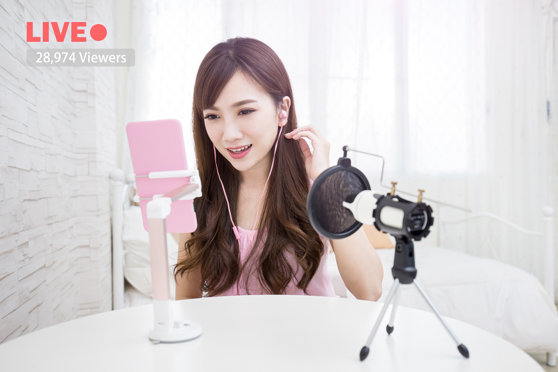 A young social media influencer broadcasts a live video.