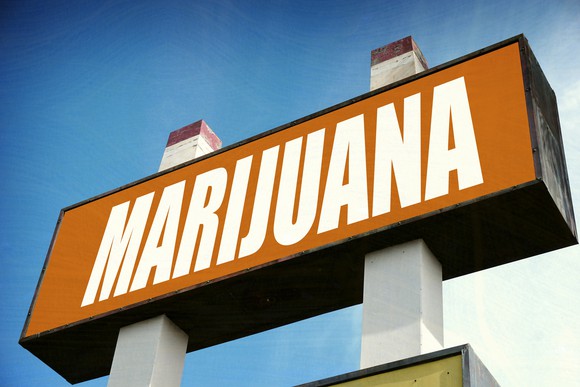A large cannabis dispensary sign that reads, in large white block letters, "Marijuana."