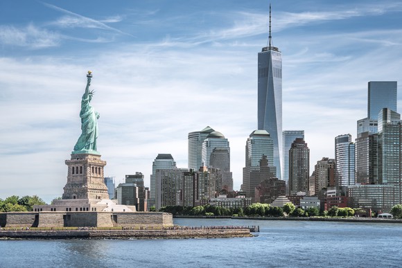 The New York City landscape, with the Statue of Liberty and World Trade Center visible. 