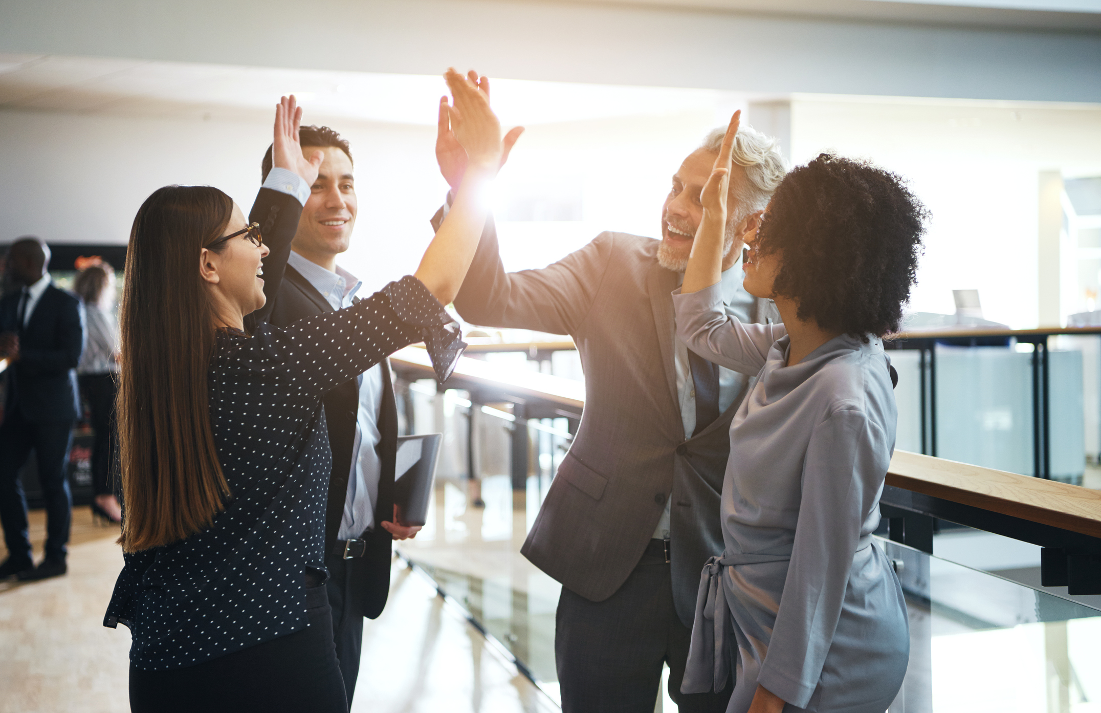 Business people giving high fives