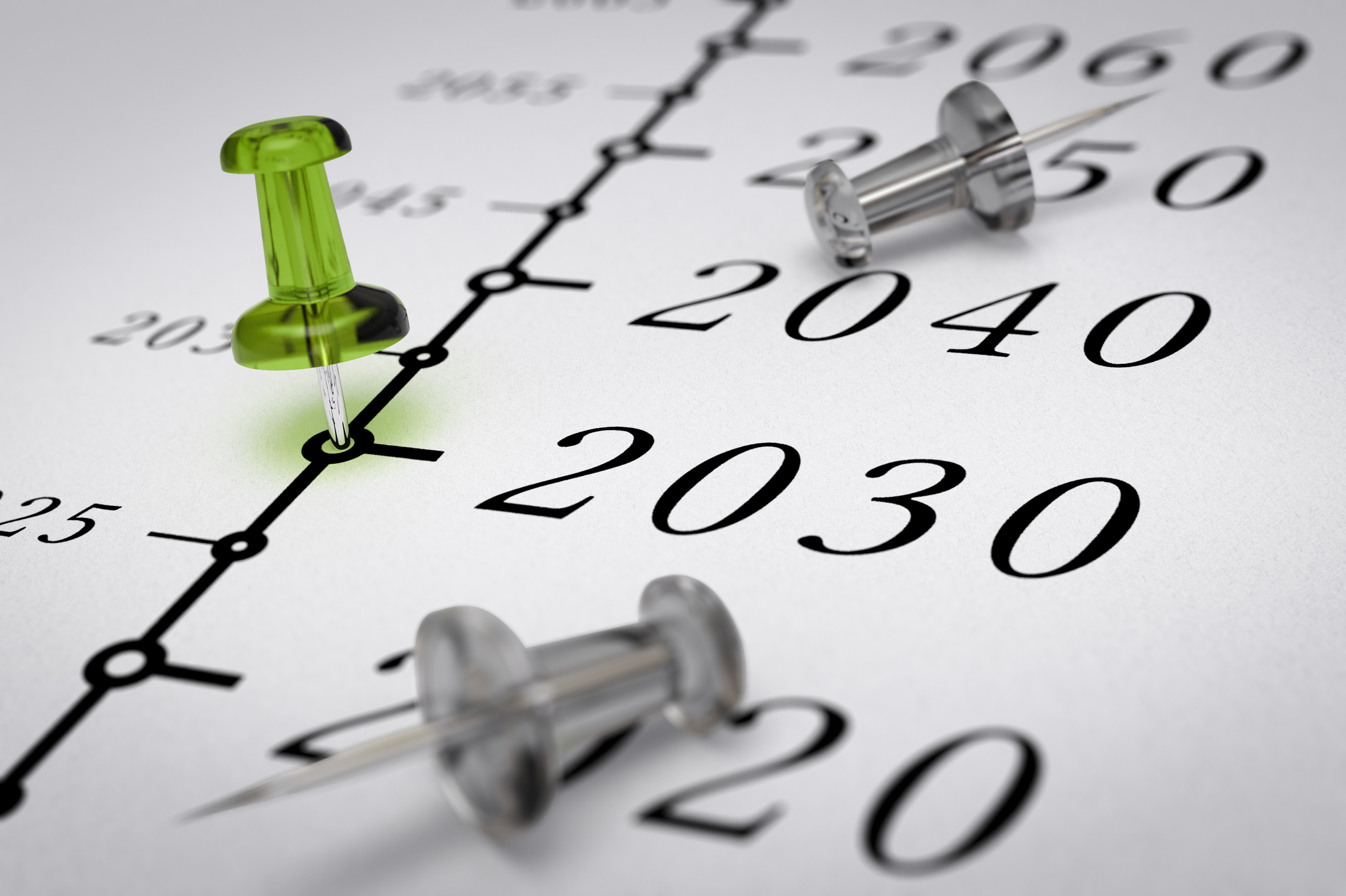 Year 2030 written on a paper with a green pushpin beside it.