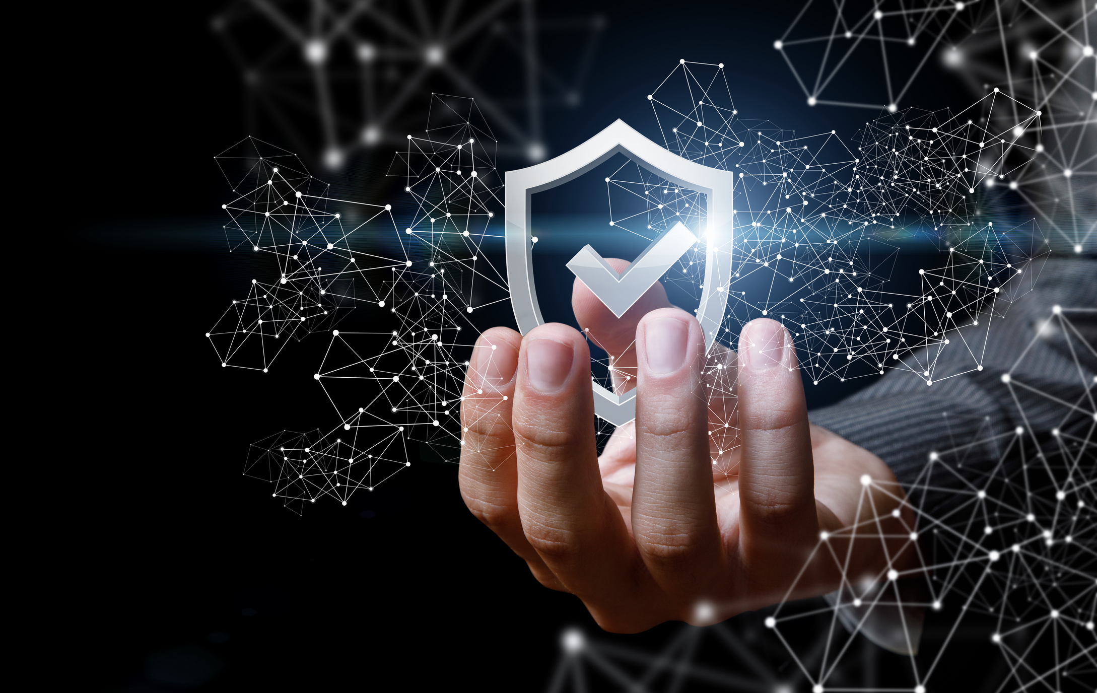 A businessperson holding a digital-like shield