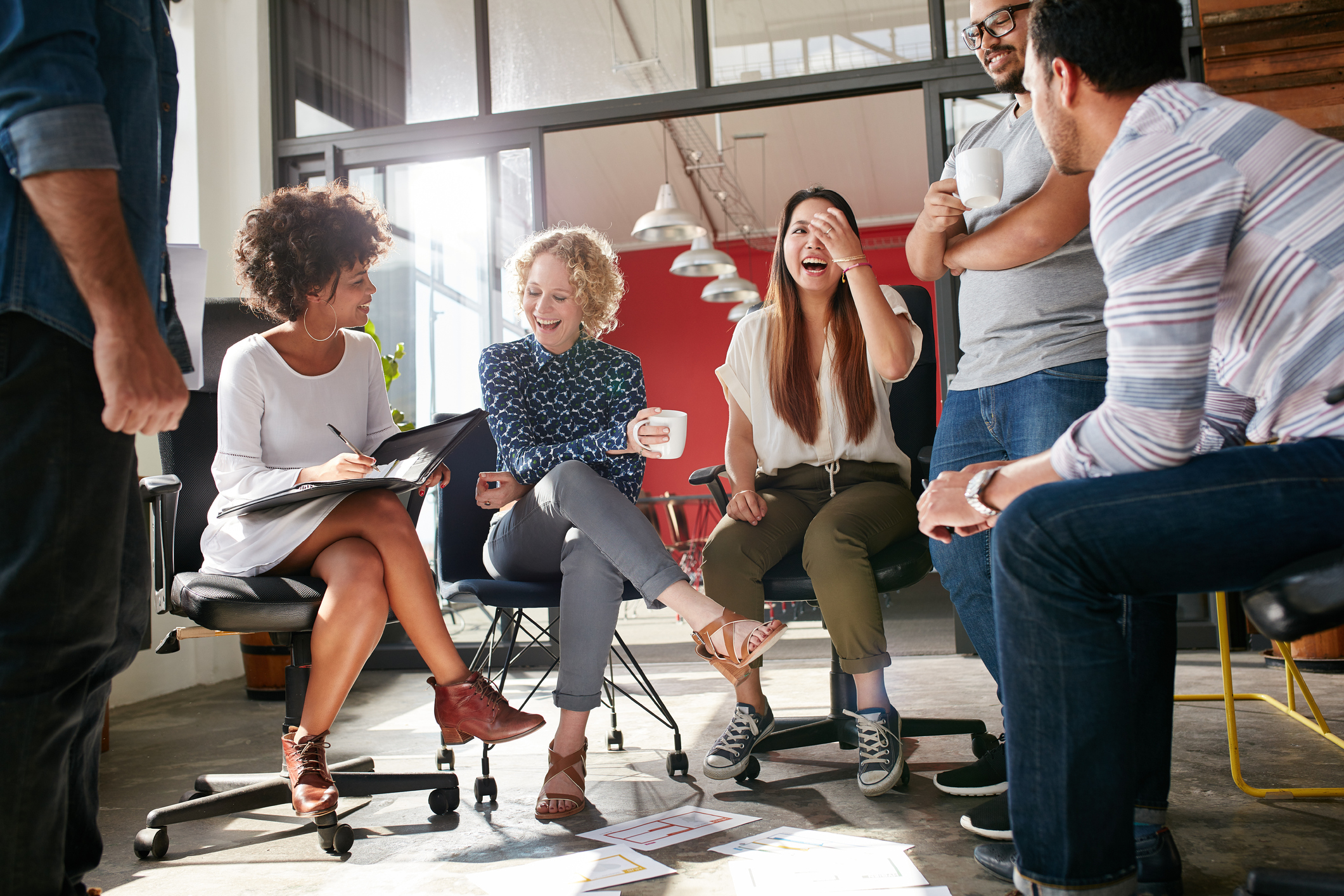 Employees sitting in a meeting while laughing
