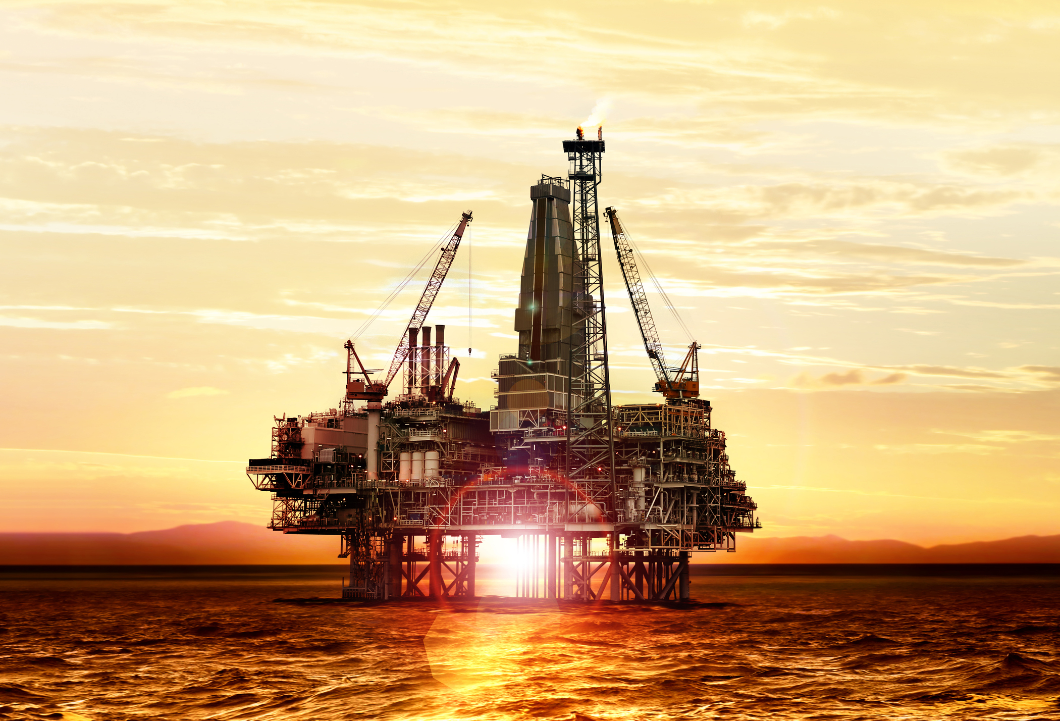 Offshore oil rig at sunset.