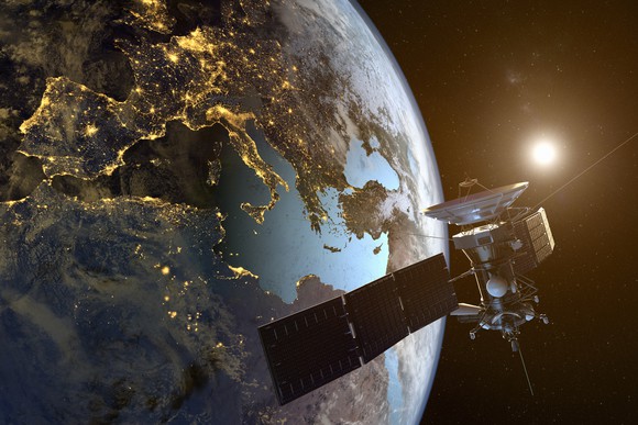 Satellite in orbit with earth in the background.
