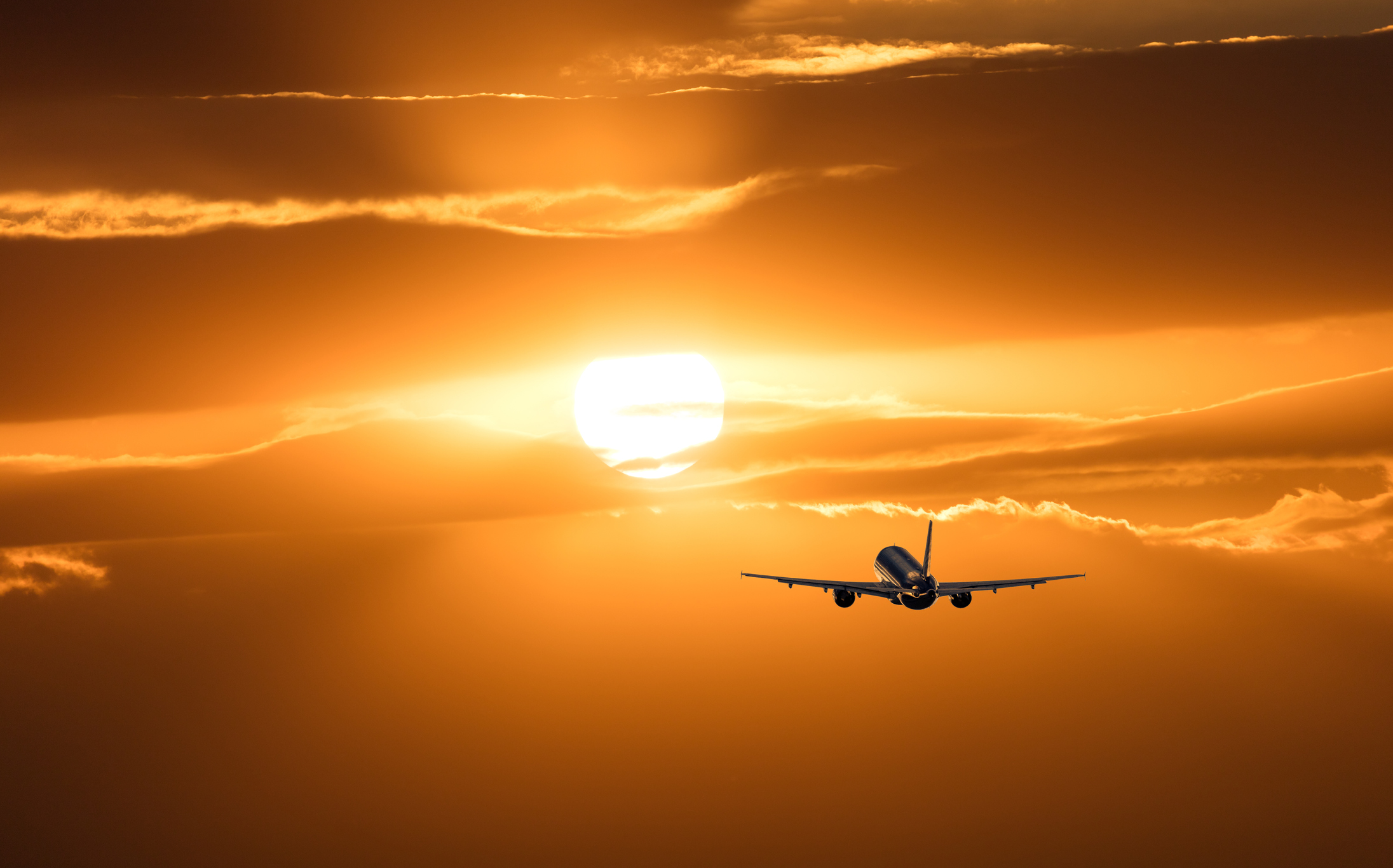 Airplane taking off at sunset.
