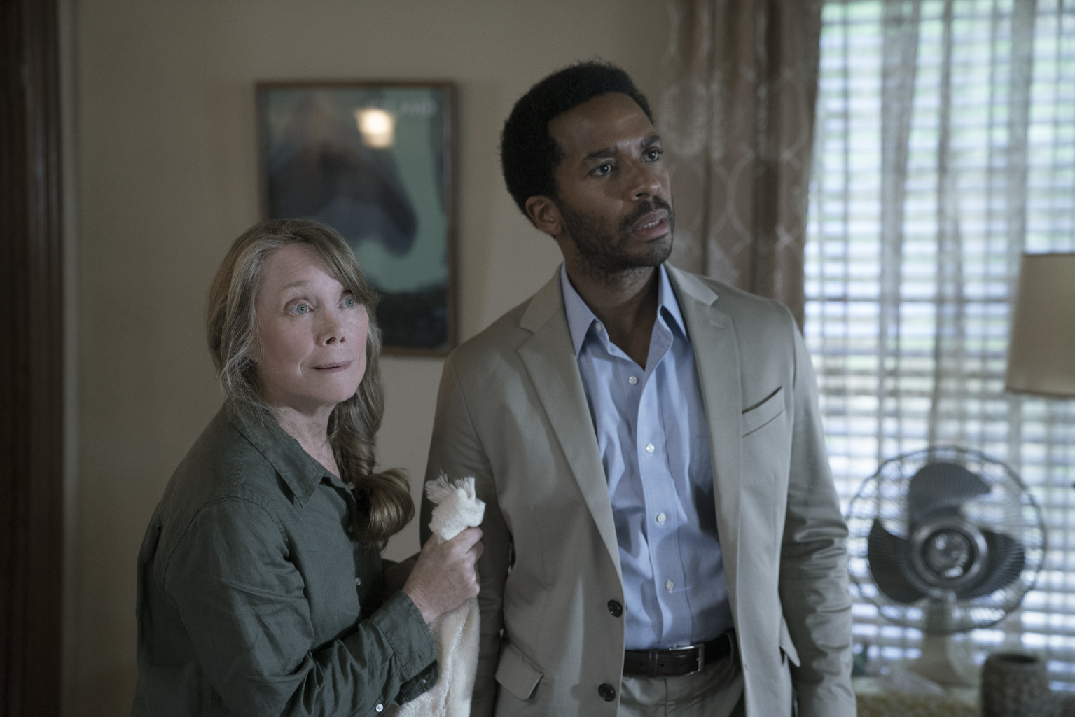 Sissy Spacek and Andre Holland, in character in a scene, looking shocked.