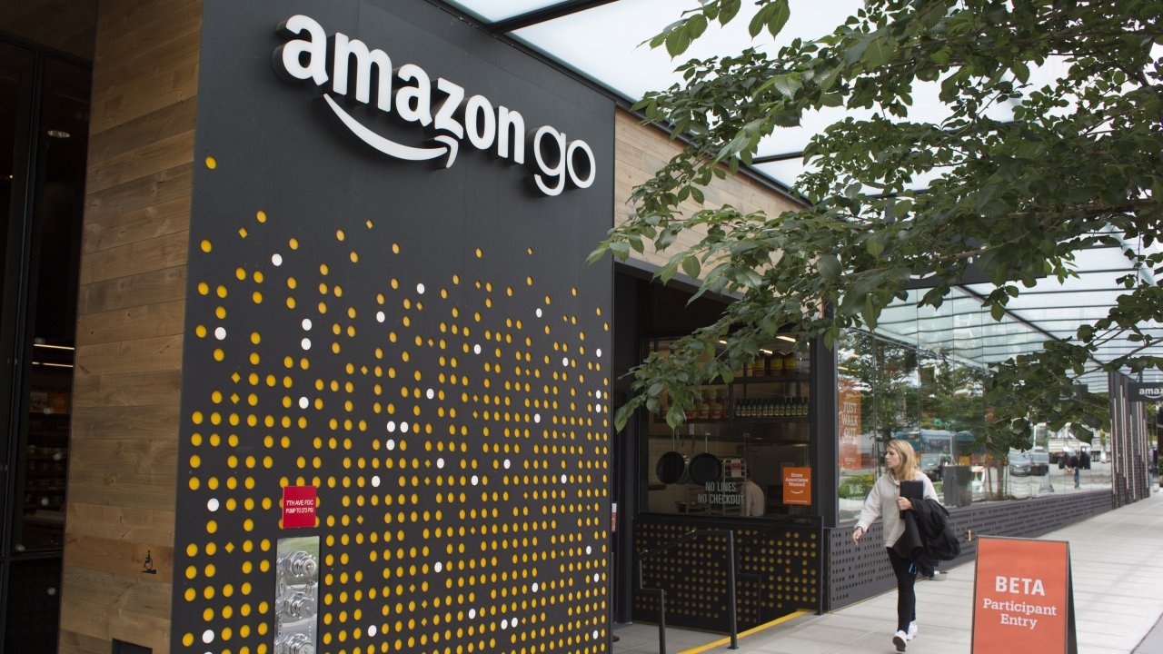 Woman walking past Amazon Go store