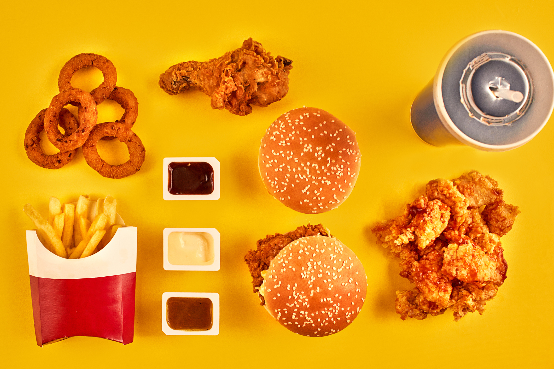 Burgers, fried chicken, fries, onion rings, and cola.