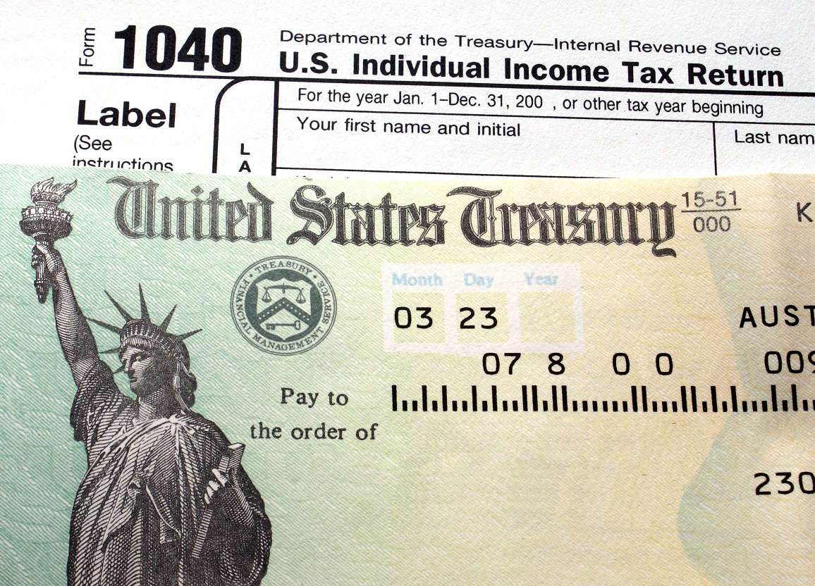 Tax refund check from U.S. Treasury, along with a 1040 form.