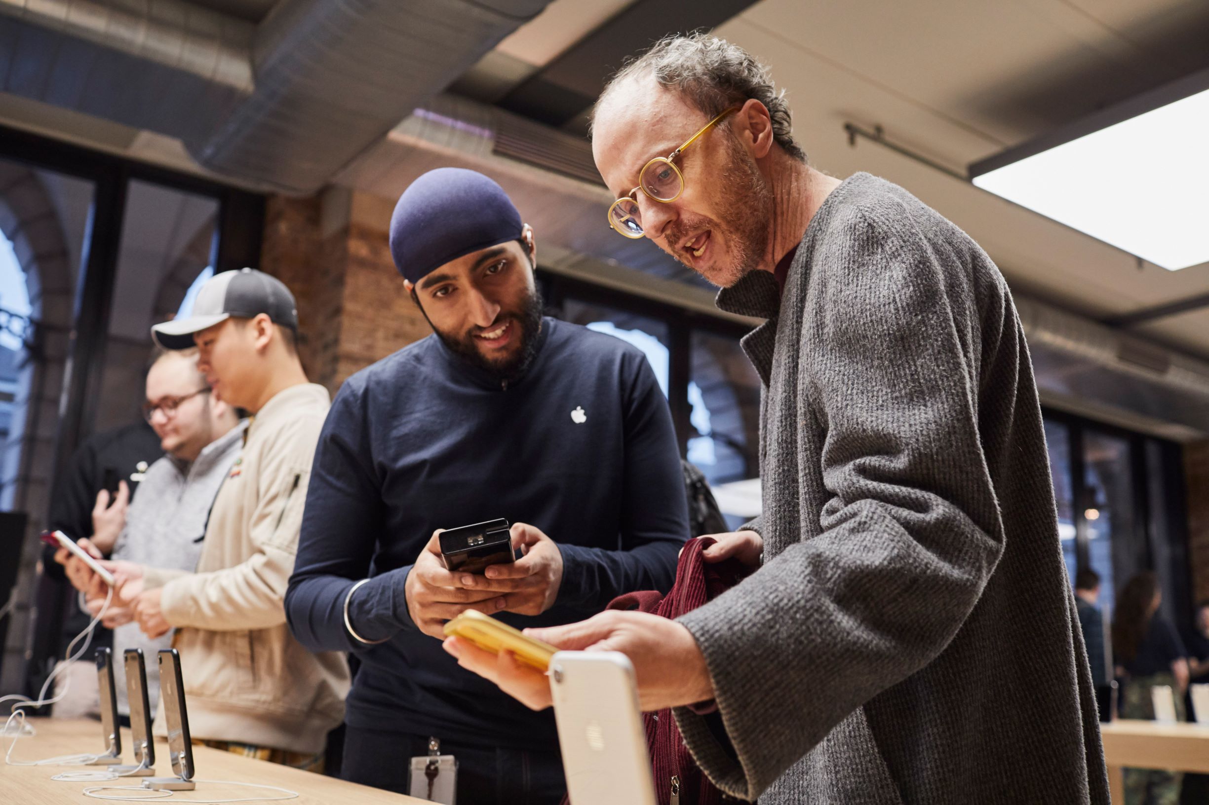 An Apple store employee with a customer.