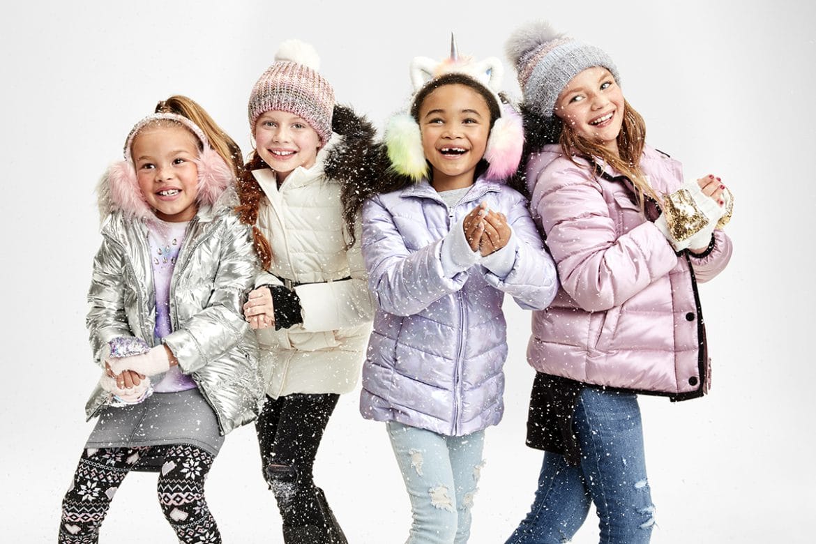 Four kids wearing winter jackets.