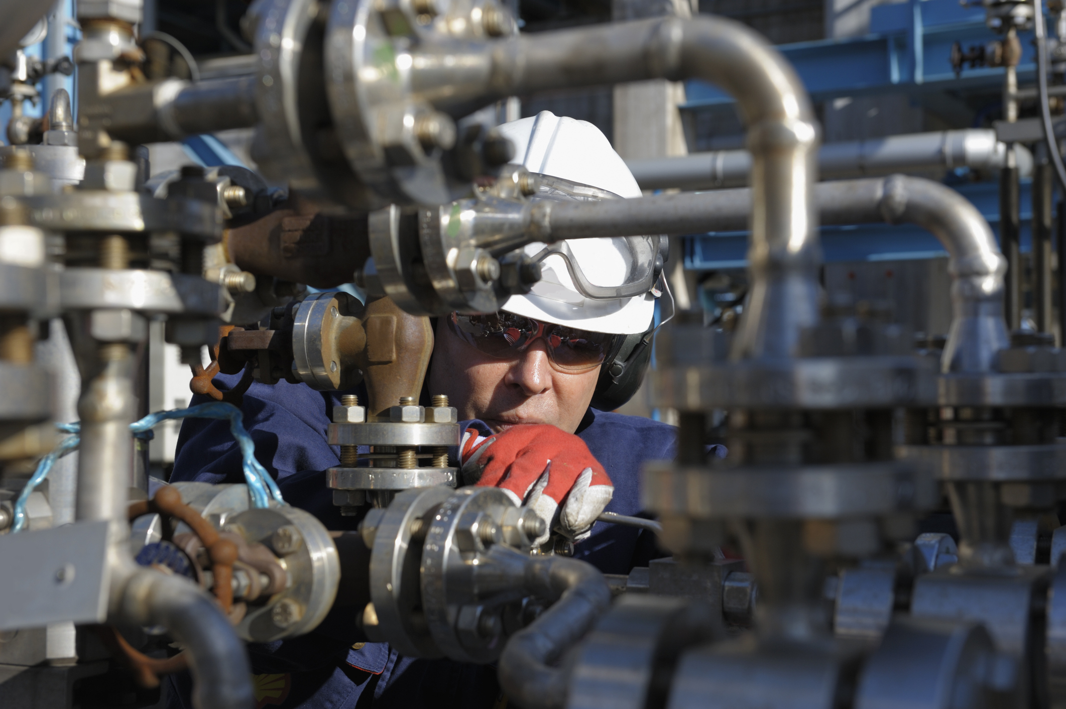 Oil services worker inspecting valves.