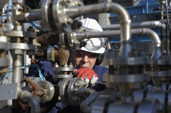 Oil services worker inspecting valves.