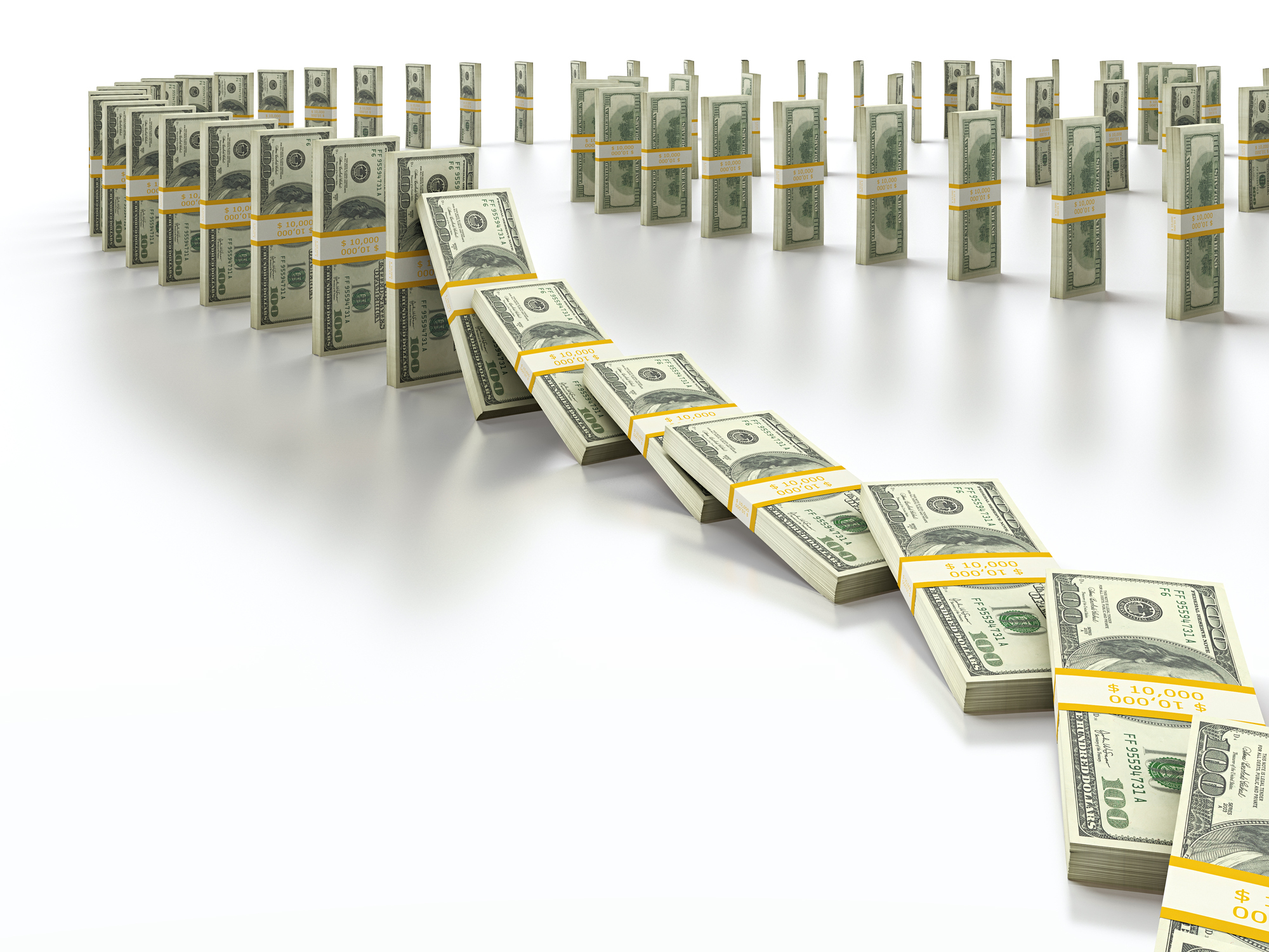 Stacks of cash placed vertically and falling like dominoes.