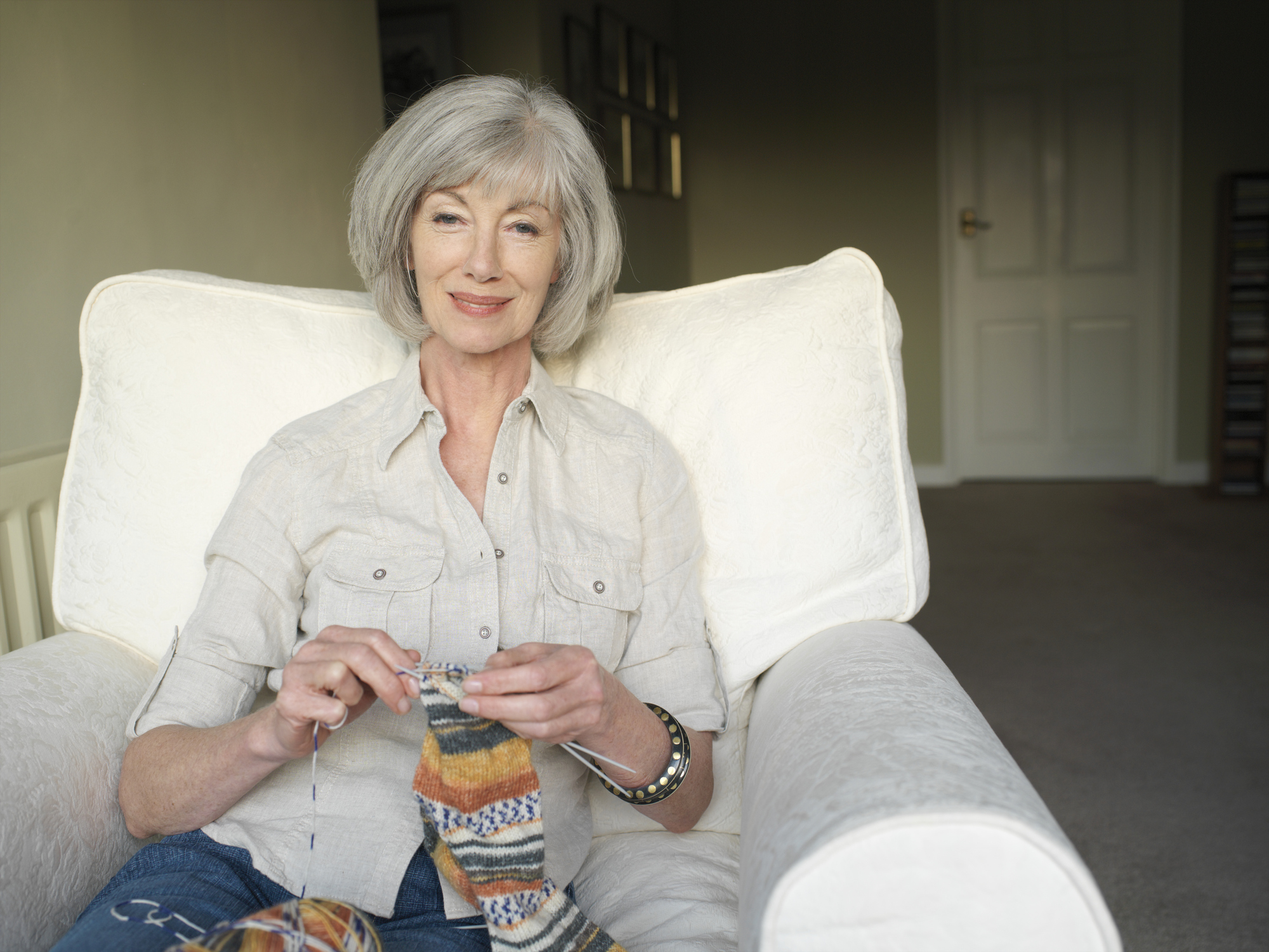 Woman sitting in chair, knitting