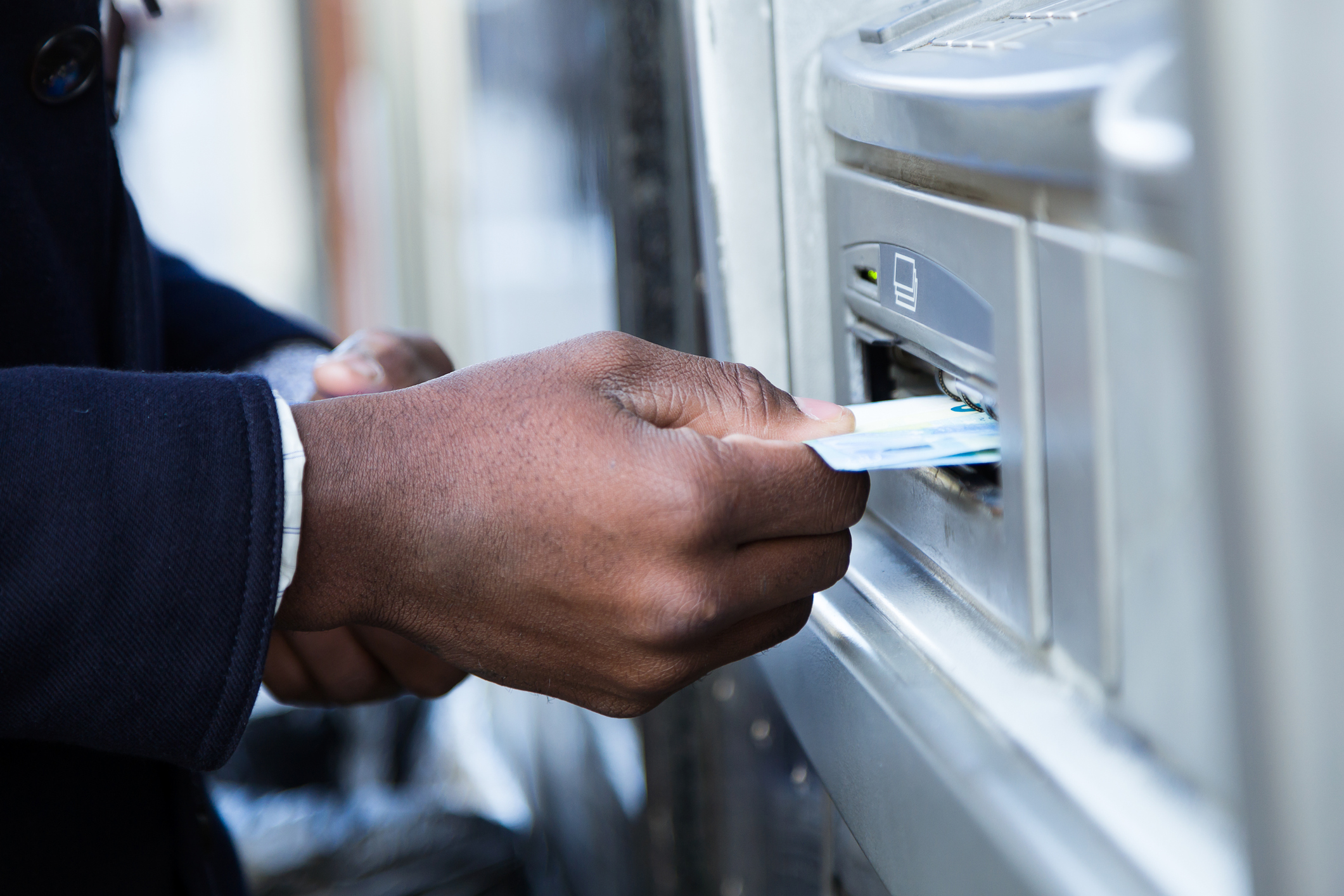 Person using ATM machine.