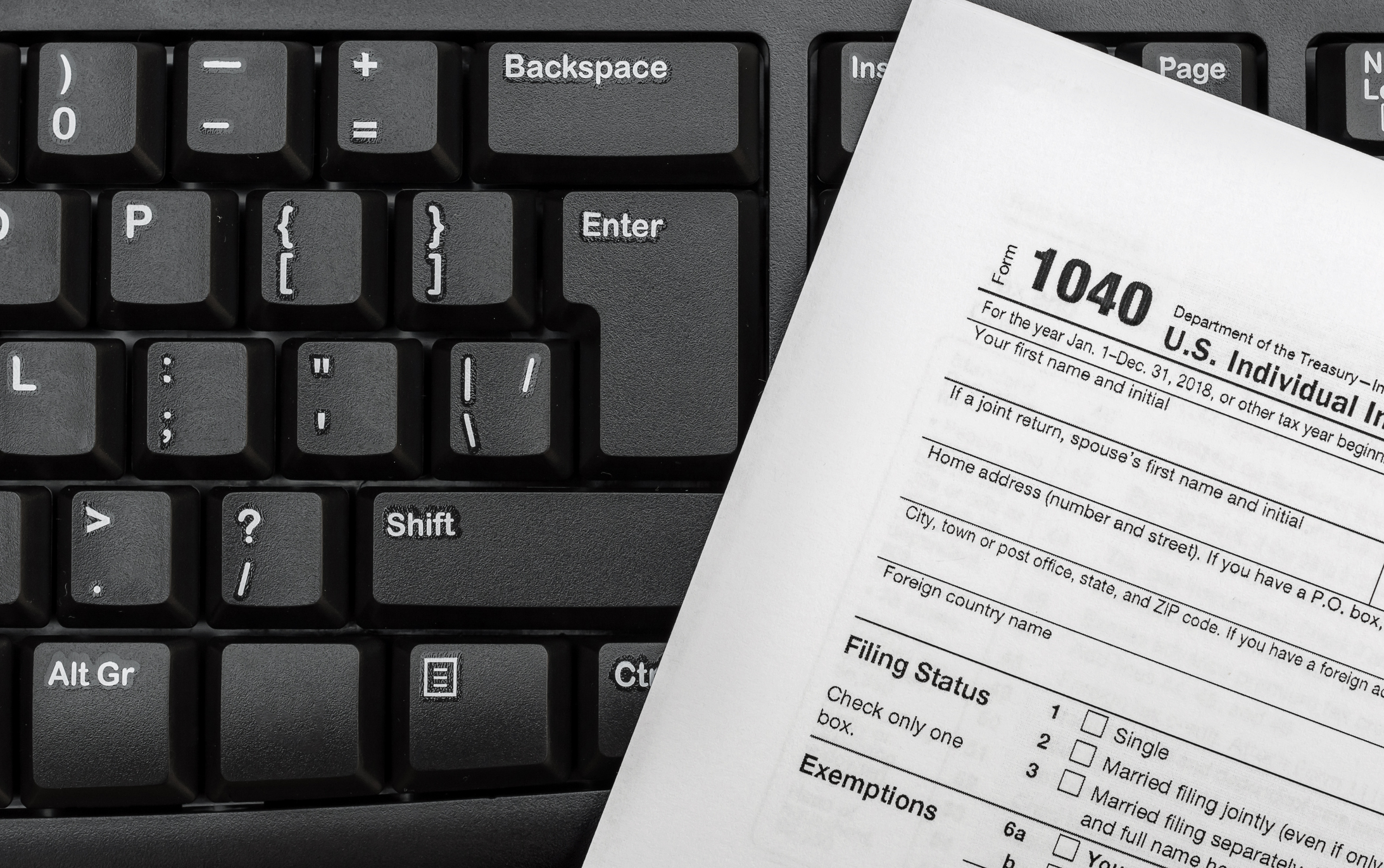 Tax form resting on computer keyboard