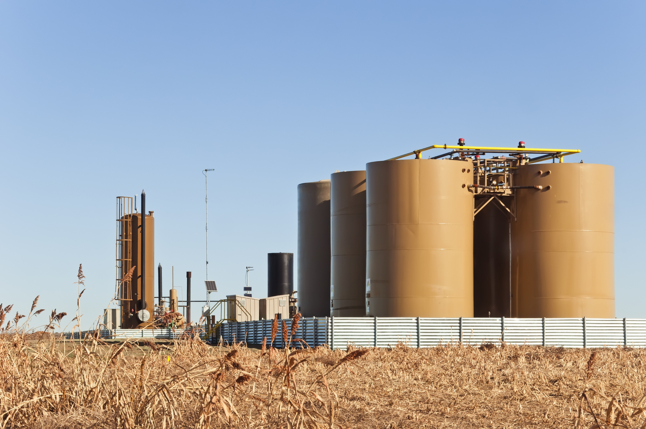 Storage tanks and a treater for separating water from crude oil and natural gas.