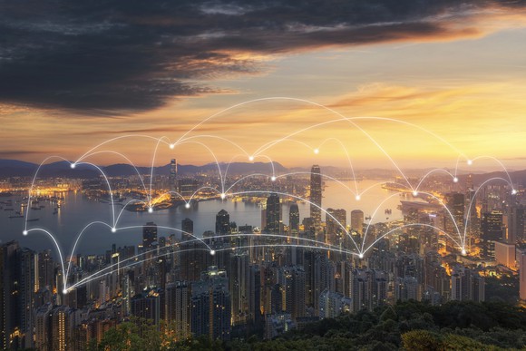 A cityscape in the evening with lines connecting dots on top of it