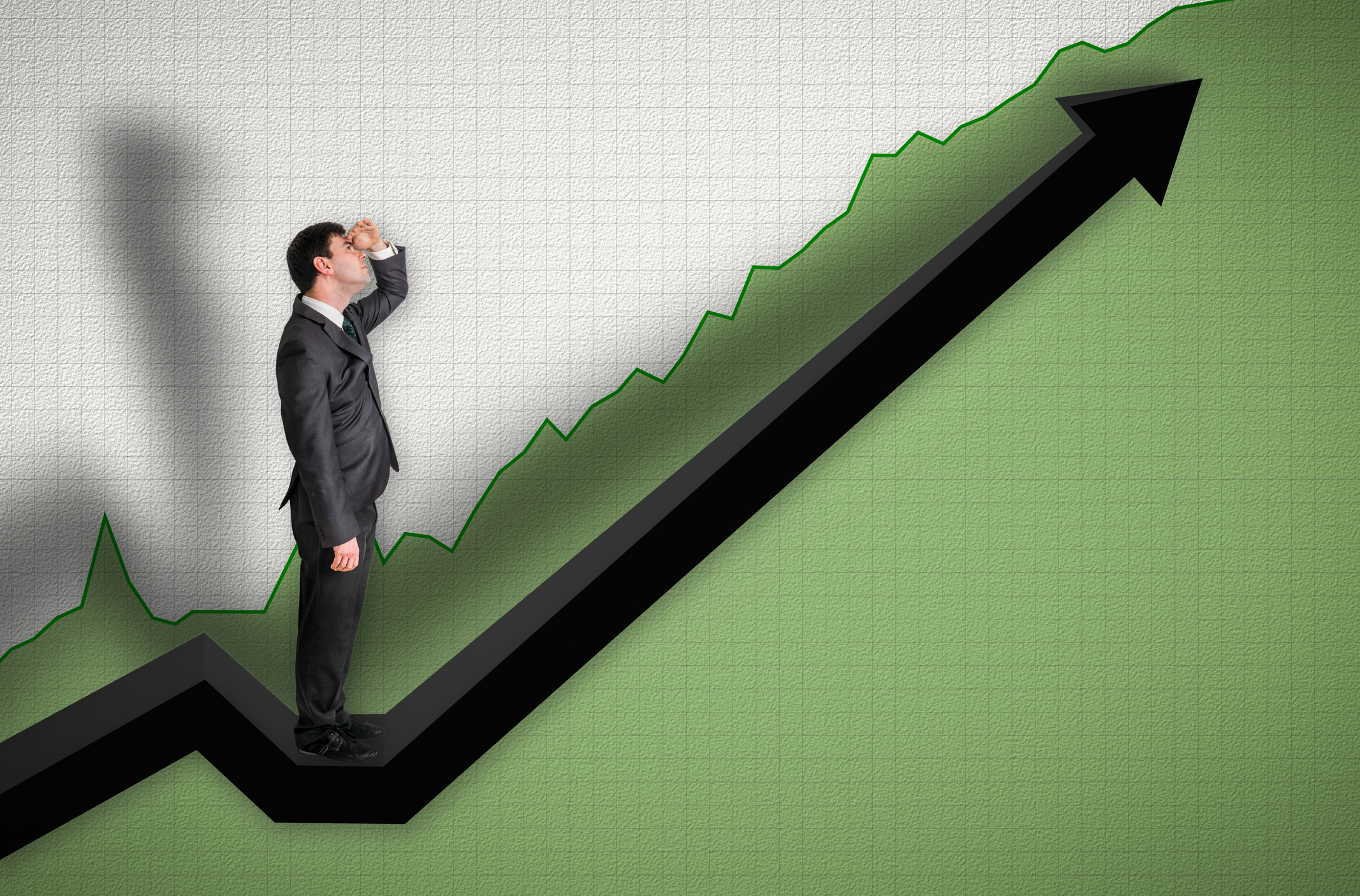 Businessman looking at chart going up.