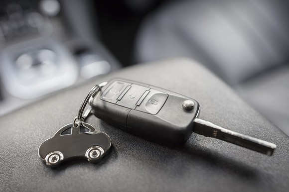 Car key sitting on top of a car's center console.