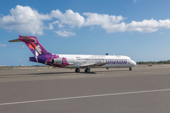 A Hawaiian Airlines jet parked on a tarmac.