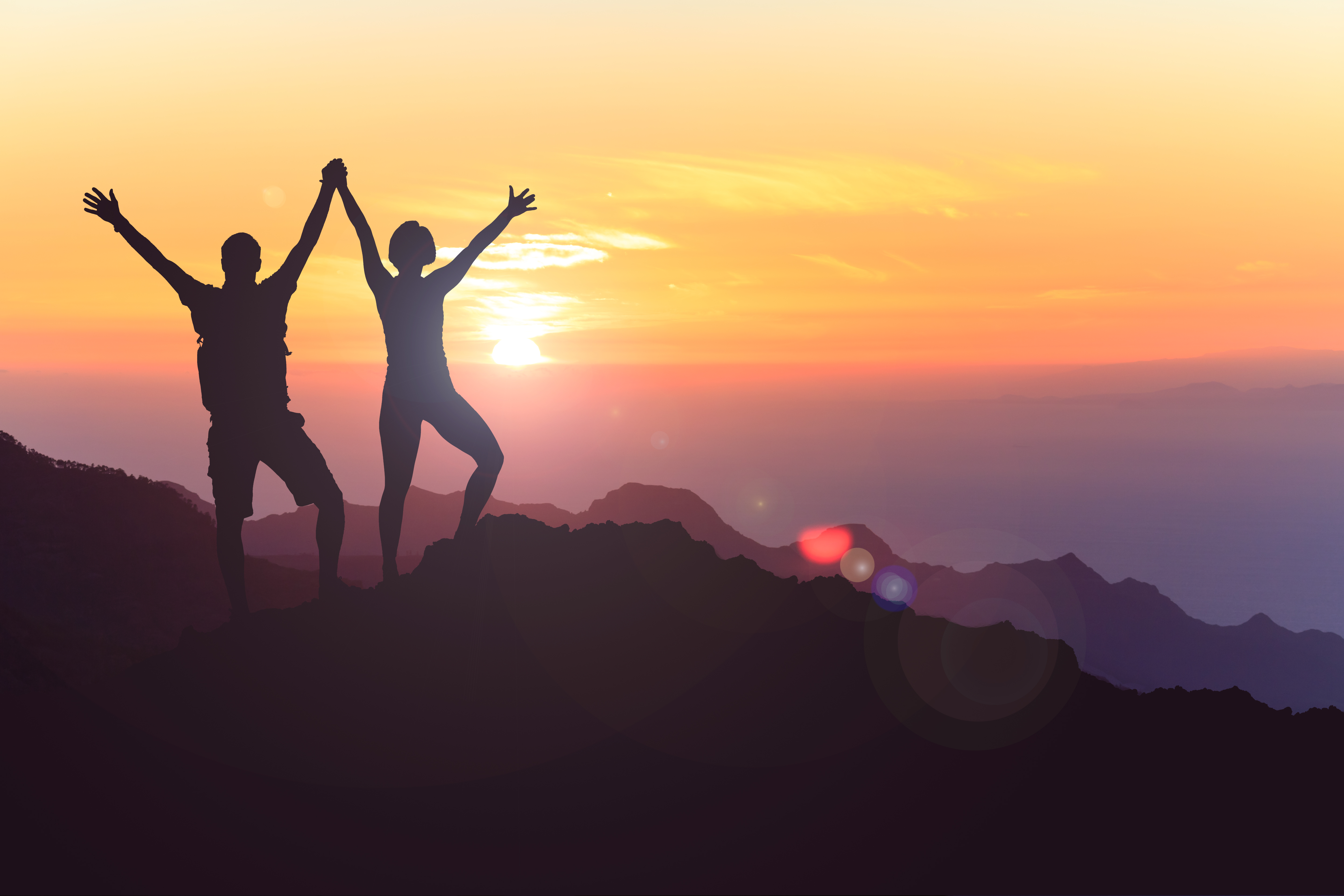 Two people celebrating outdoors.