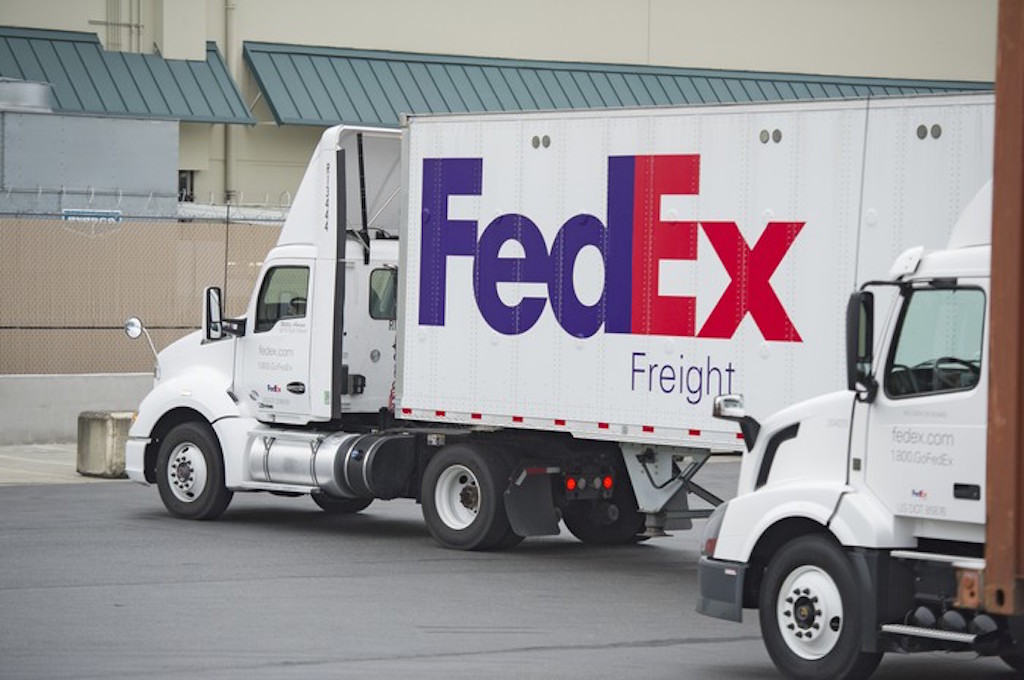 A FedEx truck at a warehouse.