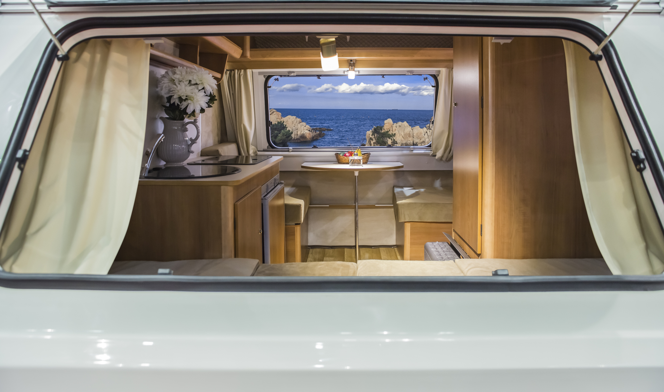A glimpse of the ocean through the interior of a modern recreational vehicle.